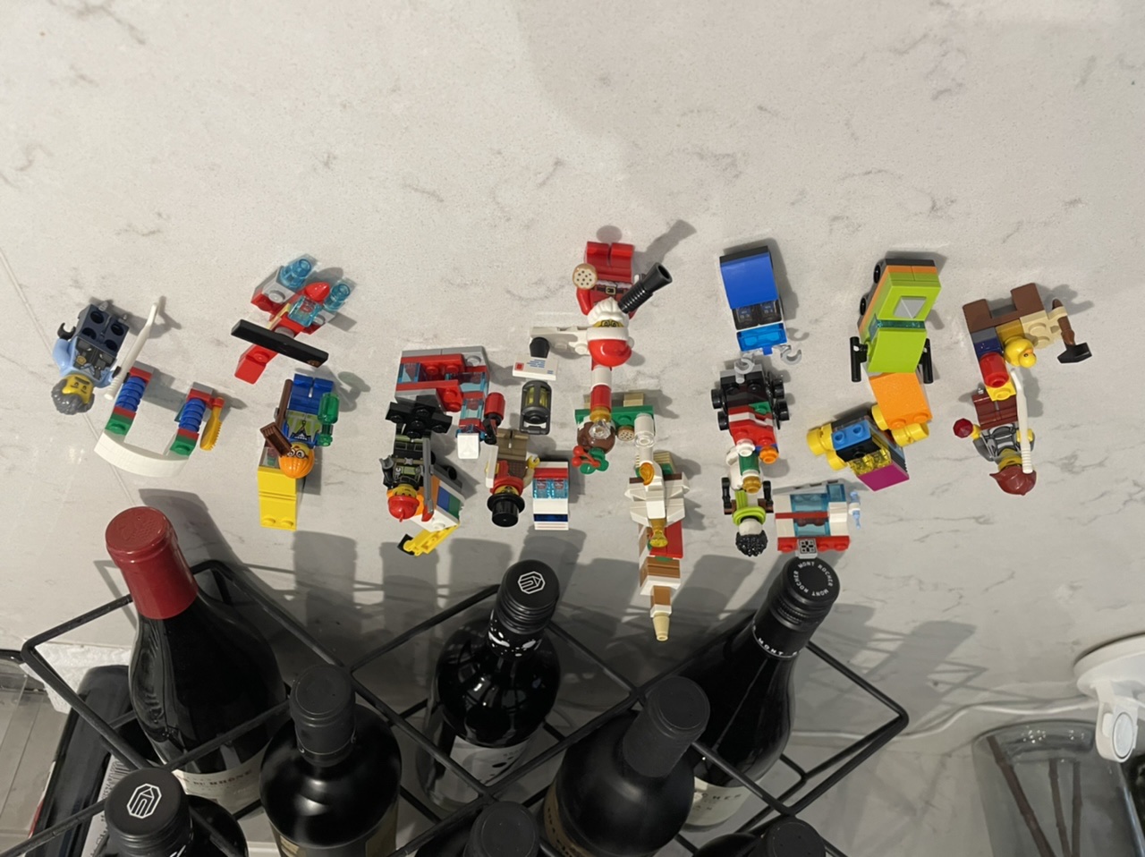 completed LEGO set with 24 different pieces, ranging from people to vehicles, with Santa in the middle